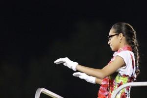 Ashley Bishop, drum major, conducts the Marching Royals at the half-time show Sept. 13. Photo by Debra Thomas.  