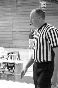 Certified referee Mark Briley blows the whistle to alert the players of a potentially game changing call. Briley has been referring for twenty years.  Photo by Ian Kelty. 