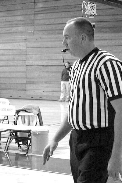 Certified referee Mark Briley blows the whistle to alert the players of a potentially game changing call. Briley has been referring for twenty years.  Photo by Ian Kelty. 