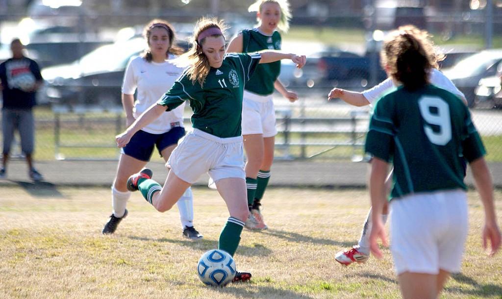 Now junior Chaelin Magrueder takes an opportunity to pass the ball to a teammate durign a game versus Meadowbrook in the 2013 season. Magrueder plans on playing again in the 2014 season. Photo by