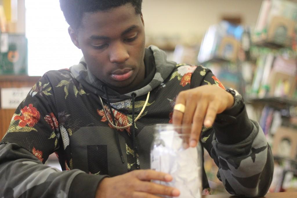 Senior Lavelle Baines puts another page into his jar. Baines tracked his fitness progression by using his method and encourages others to adopt this tradition as well.
Photo by Angelica Martinez