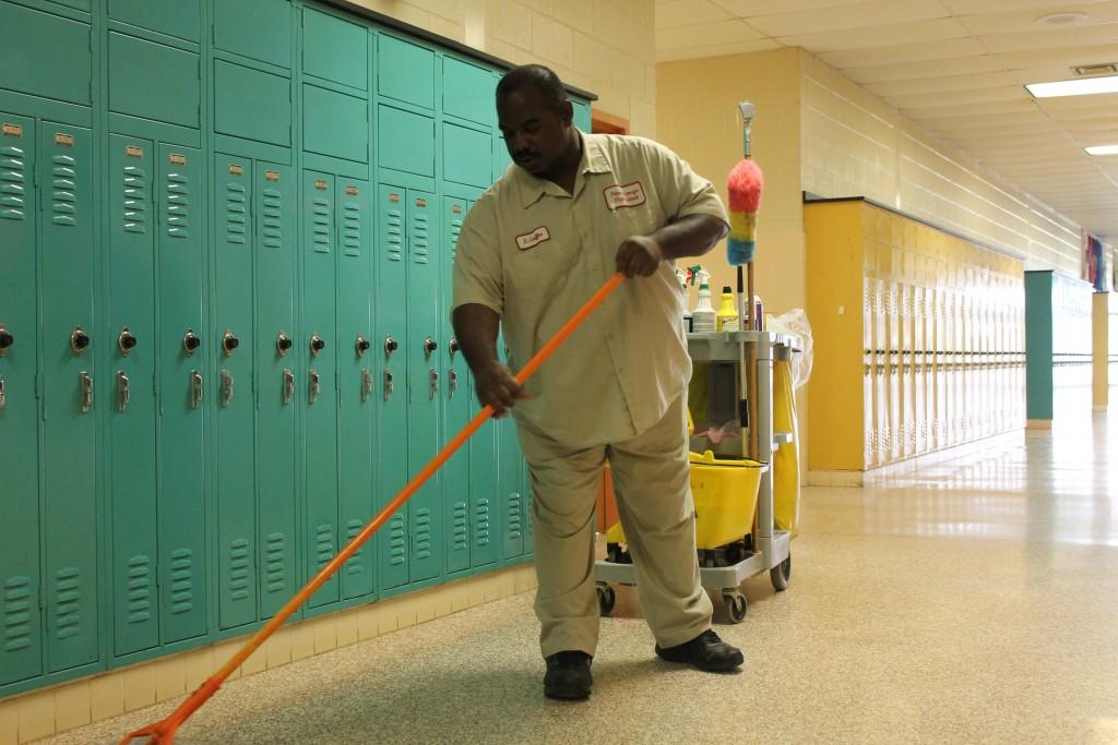 Head Custodian Bryan Griffin  mops up water leaked  onto the floors during the latest snow storm. Classrooms  in  A and B-wing  have leaked the most during this year. Ceiling tiles must be removed until the roof is fixed.  Photos by Rosemarie Hopkins and Angelica Martinez.