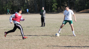 Alumnus Cameron Smith maintains possession of the ball while being defended during last year's boys soccer tryouts. Photo by Daniel Puryear.