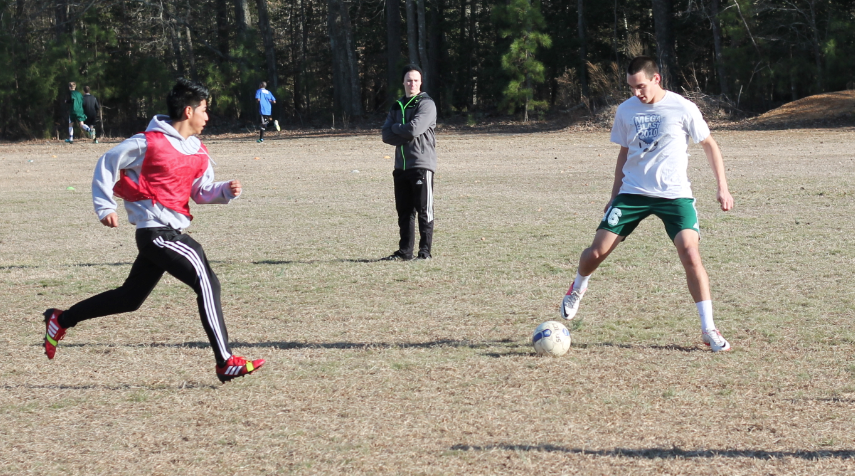 Alumnus Cameron Smith maintains possession of the ball while being defended during last years boys soccer tryouts. Photo by Daniel Puryear.