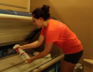 Local Tan N’ Time employee  sanitizes one of the tanning beds. Photo by Sarah Diaz.