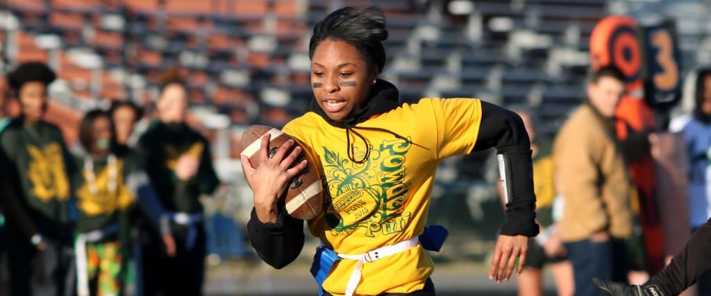 Senior Amiracle Powell carries the ball in the Powderpuff game against the junior. Seniors won the game in overtime.