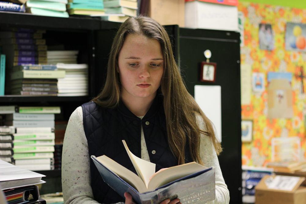 Junior Ashley Thacker, reading a book on poetry, is currently still an active member of the PACE program which is sponsored by Beth Andersen.