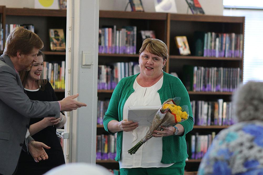 Teacher+of+the+Year+Jan+Buetow+accepts+her+award+from+English+teacher+Beth+Andersen+on+Tuesday%2C+March+19th+at+the+faculty+meeting.+Photo+by+Royals+Media+Staff.