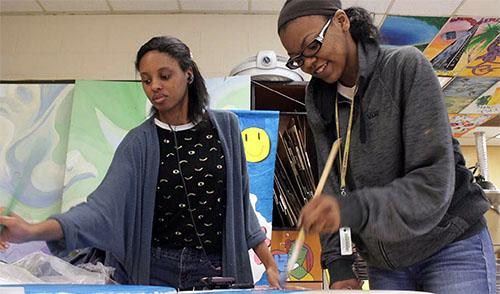 Seniors Janai Austin and Millie McSwain paint bases for their sculptures. Austin and McSwain were two of only three students who took AP Studio Art at PGHS this year. Photo by Anna Mitchell.
