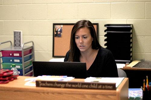CTE Teacher Ashley Molter helps students log-on to Virtual Virginia account.