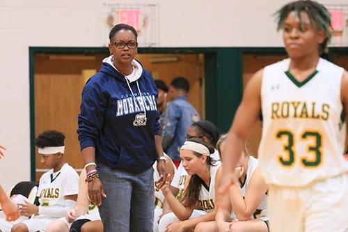 New varsity girls head coach Kenya Grissett yells out a play that she wants her girls to run. The Royals went on to beat the Dinwiddie Generals  54-30. Photo taken by Deana Nichols.