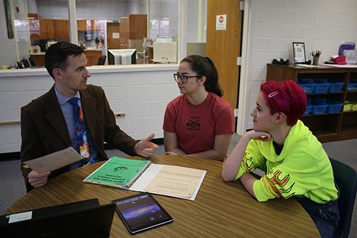 Levi Owens discusses with Elizabeth Christian (middle) and Sam Martin (right) the final due dates and meetings that were pushed back due to snow day last Friday the 21st, 2020.
