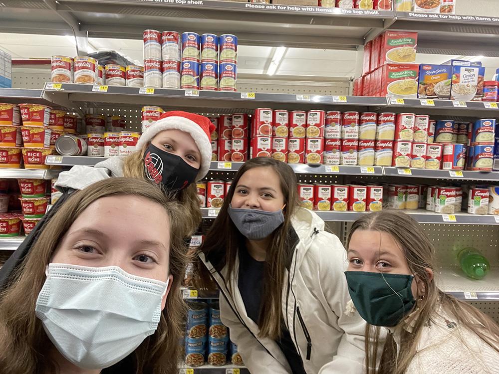 Seniors Haley Hines, Ande Davis, Mallory Thompson, and Kassidy Reed gather to purchase canned food for the Key Club food drive. Photo contributed by Haley Hines.