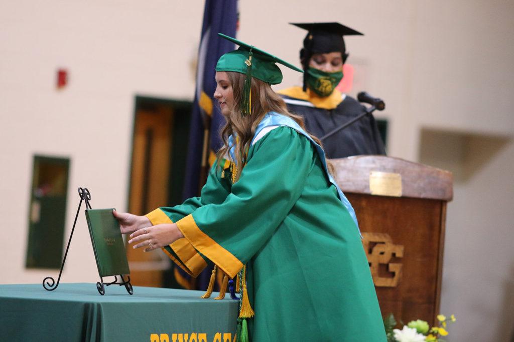 2020 graduate Madison Cleveland  receives her diploma in last year’s ceremony.  The graduation ceremonies, both this year and last year, have several adjustments to accommodate for social distancing guidelines. Photo by Royals Media. 